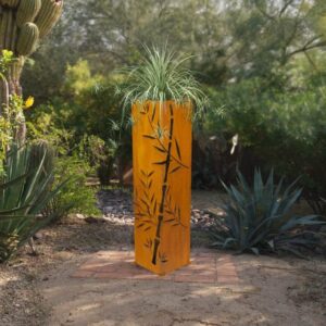 Orange decorative planter with grass in desert garden