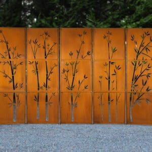 A metal fence with trees on it
