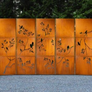 A metal screen with birds and flowers on it.