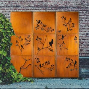 A metal screen with birds and branches on it.