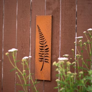 A wooden sign with a fern on it