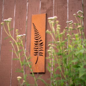 A fern sign hanging on the side of a building.
