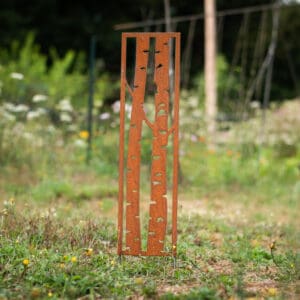 A tall metal sculpture in the middle of a field.