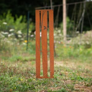 A wooden pole in the middle of a field.