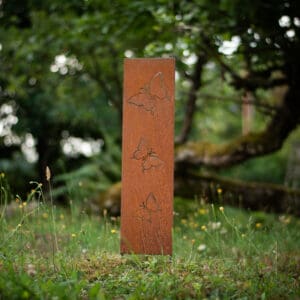 A tall sign in the middle of some grass