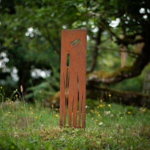 rusted metal garden stake with dragonfly cutout