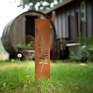 A tall metal pole with a leaf on it