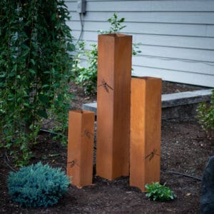 A group of four wooden posts in the ground.